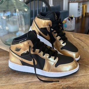 Nike Air Jordan 1 Mid SE (GS) sneakers in black and gold.